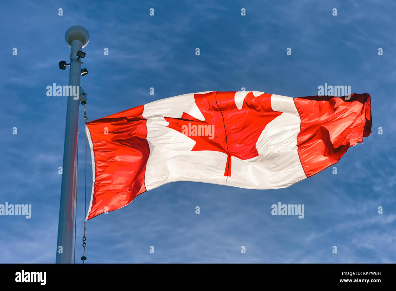 Flag of Canada flying against a blue sky in Vancouver, BC, Canada Stock Photo