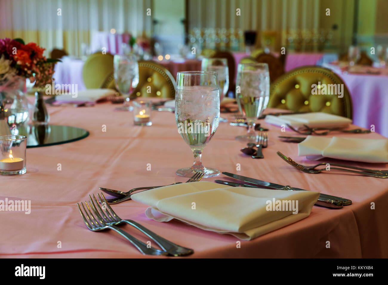 catering table set service with dish silverware and stemware glass at