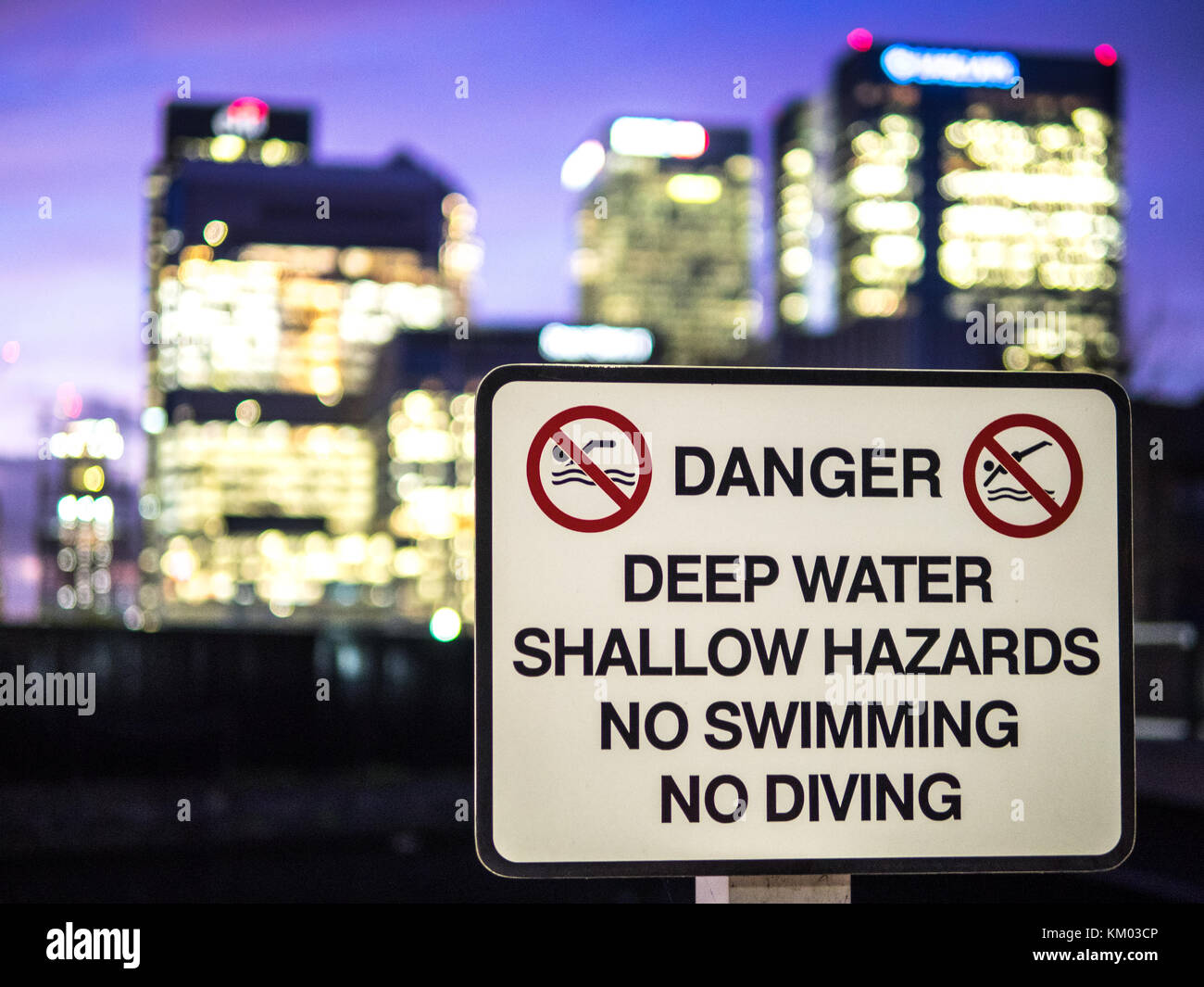 Danger Sign in front of London Banks at the dockside Canary Wharf Stock Photo