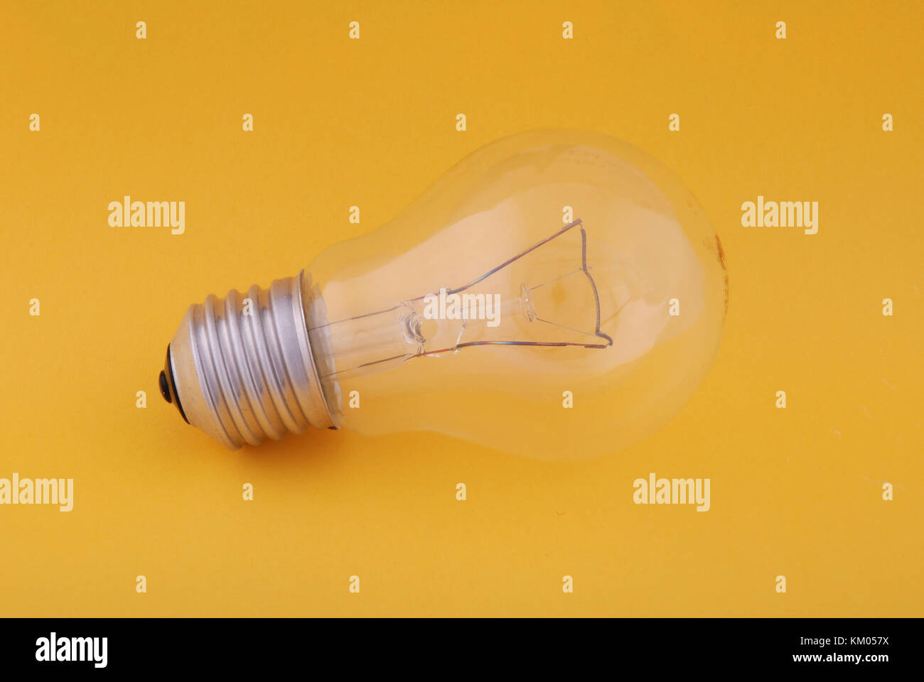 Light bulb on yellow background Stock Photo - Alamy