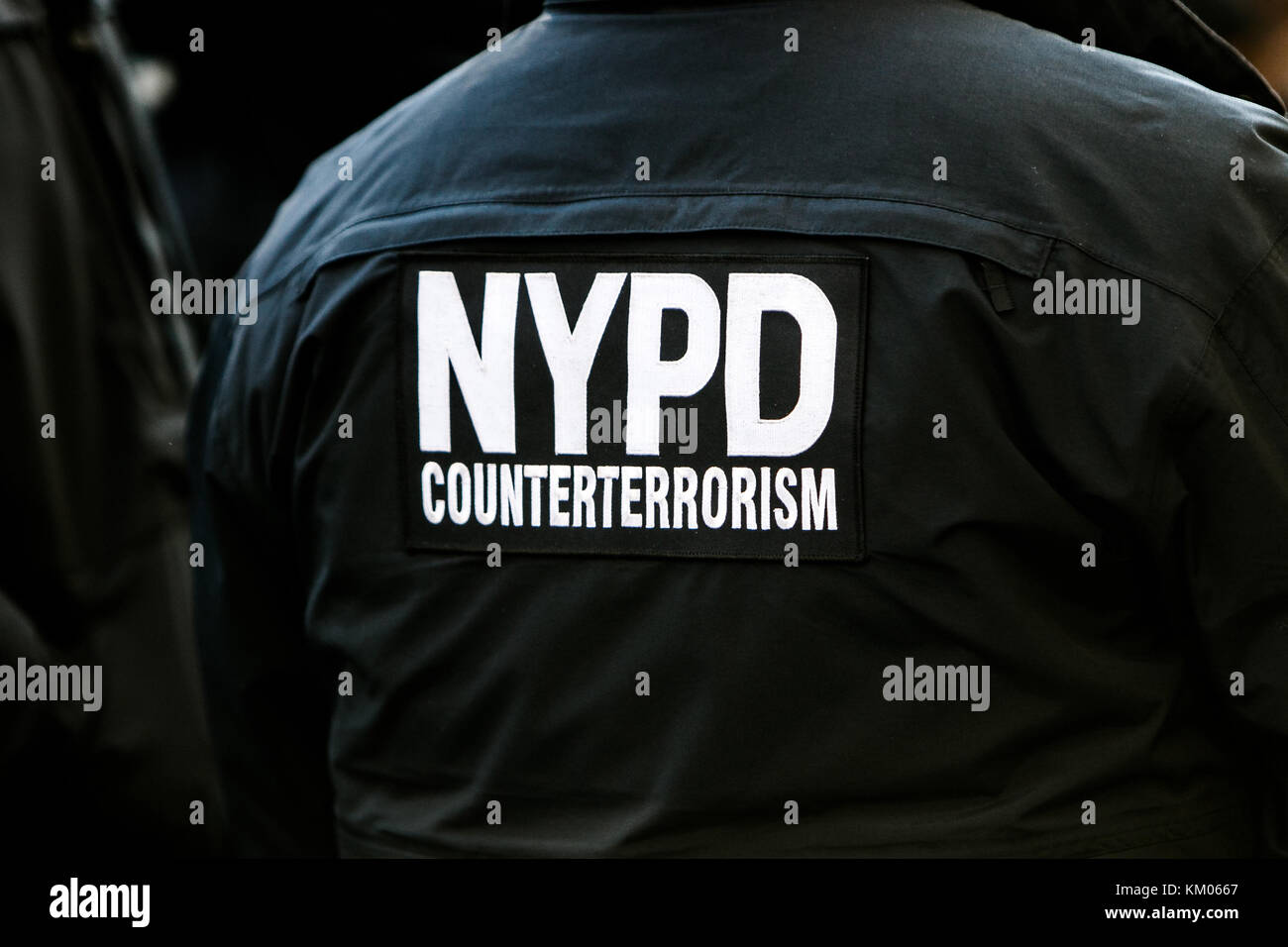 Signage on the back of the uniform of an NYPD officer from counterterrorism unit. Stock Photo