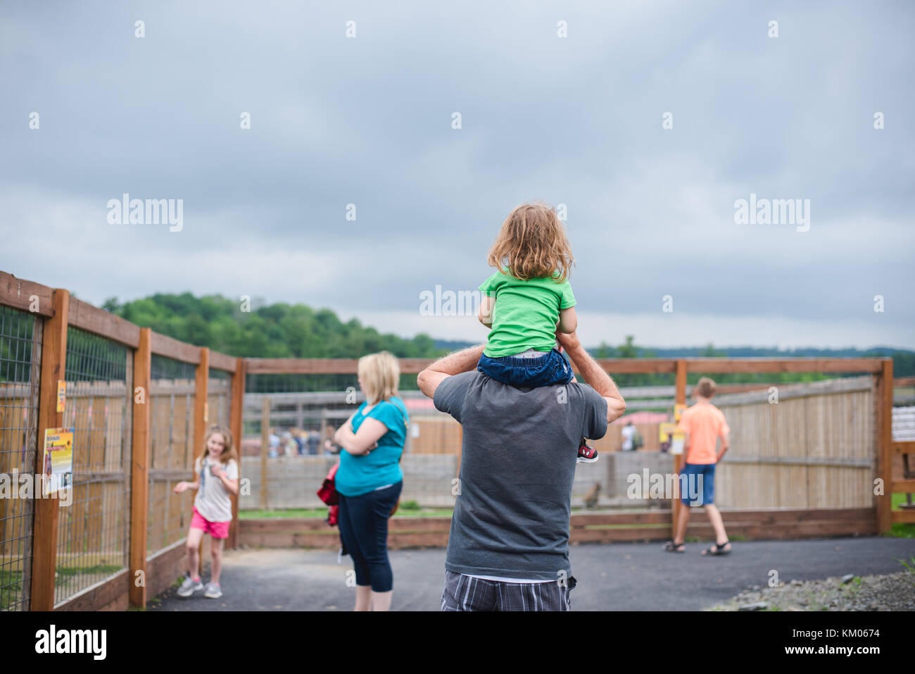 A father carries his daughter on his shoulders. Stock Photo