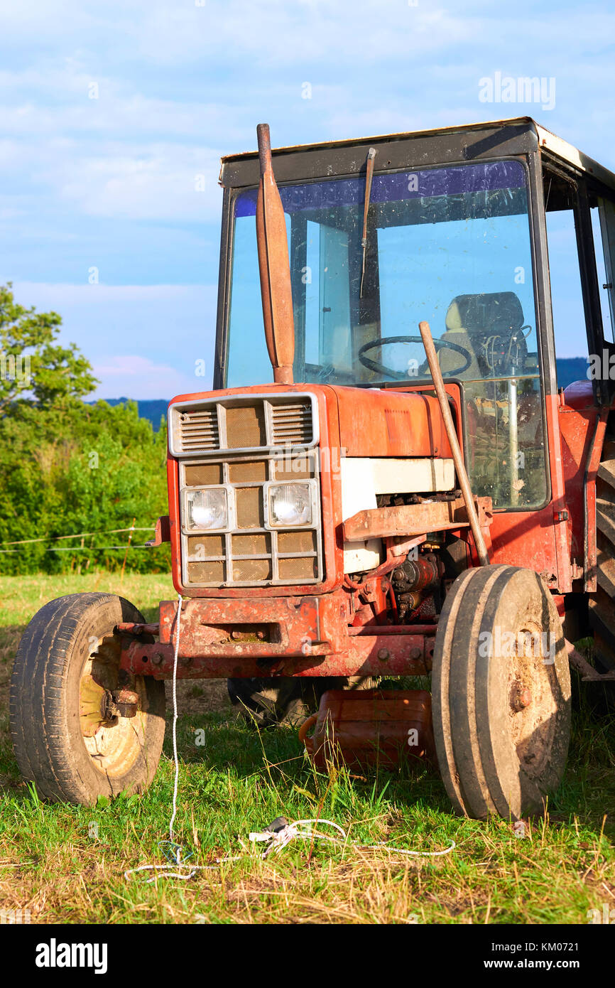 Tractor for milking parlor in the field, Franche Comte, France. Stock Photo
