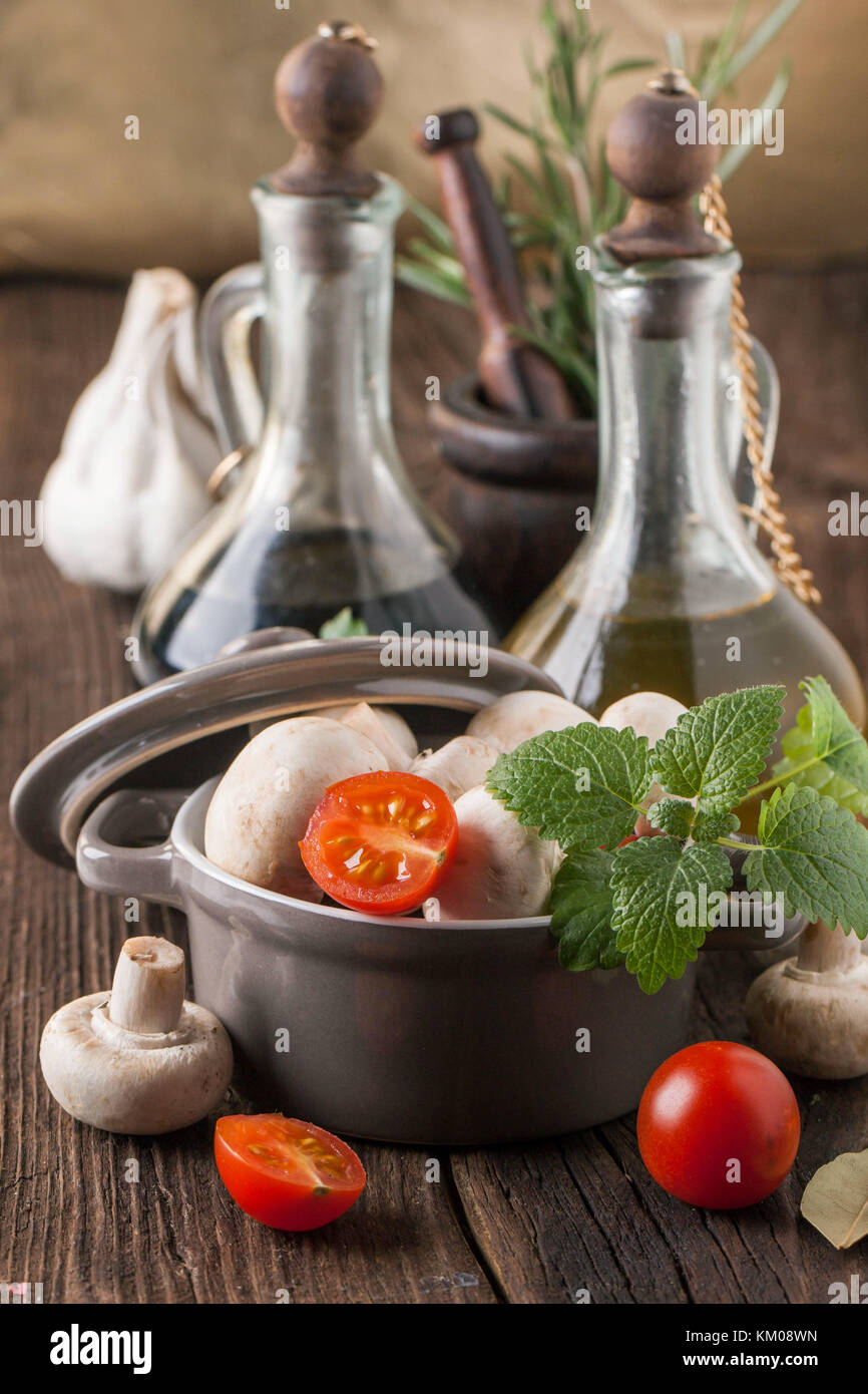olive oil and vinegar in vintage bottles on wooden table with garlic