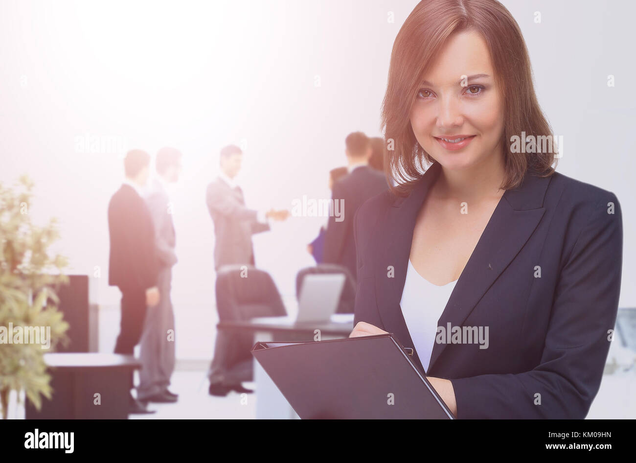 Portrait of young happy smiling businesswoman with folder Stock Photo ...