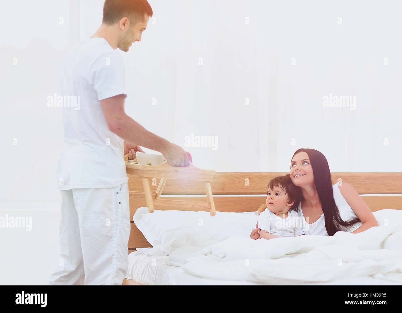 Smiling family having breakfast Stock Photo - Alamy