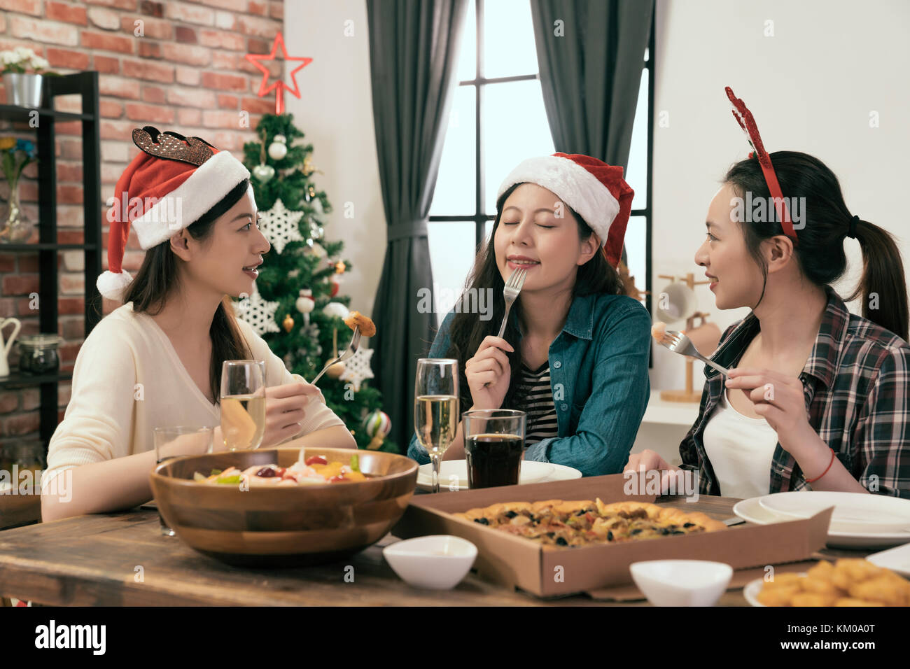 beautiful girl try out the food and celebrating Christmas dinner together at home. Stock Photo