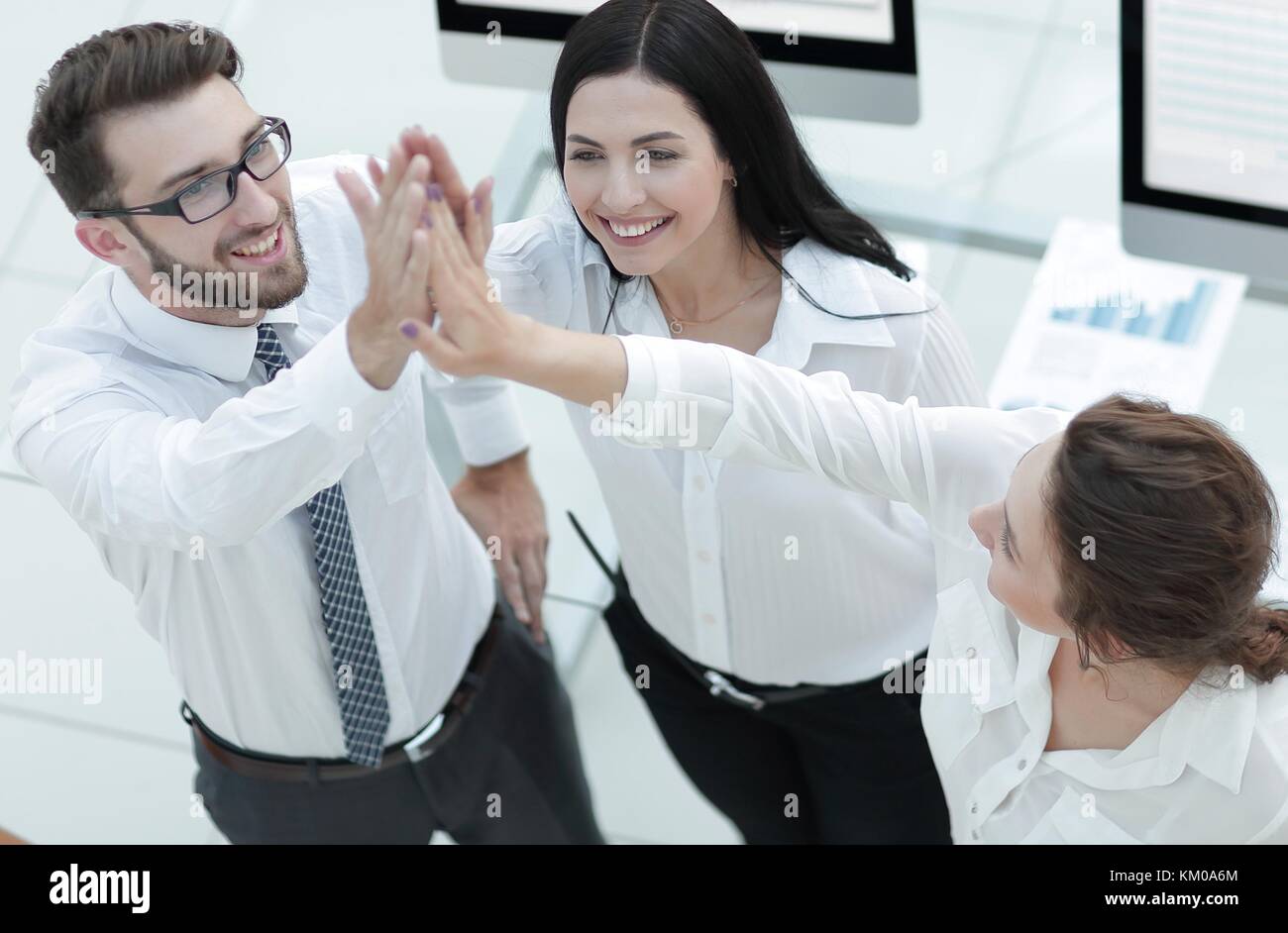 successful business team giving each other a high five Stock Photo - Alamy