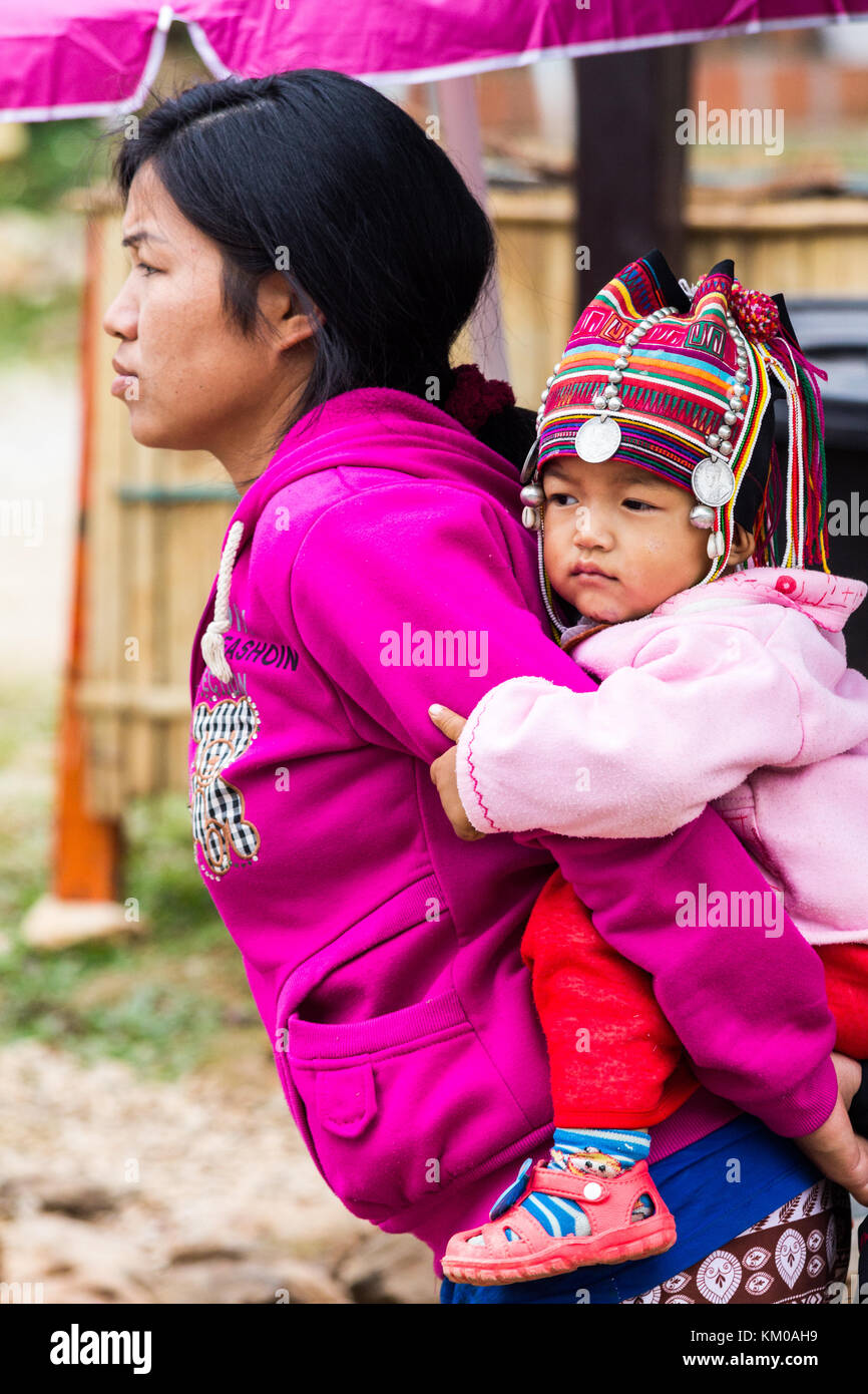 Akha hilltribe baby on mothers back, Doi Mae Salong, Chiang Rai, Thailand Stock Photo