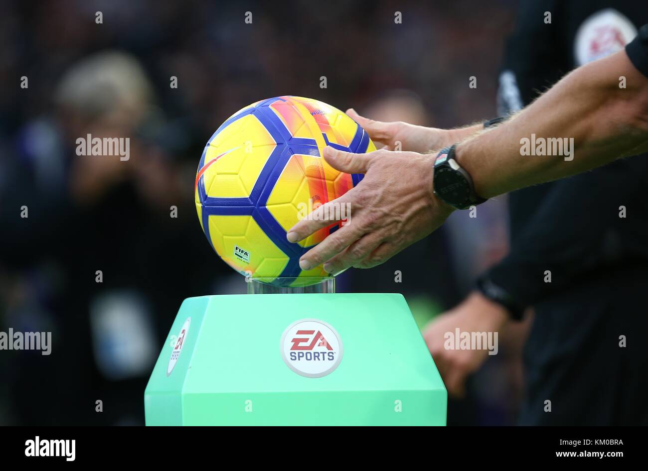 Referee Graham Scott picks up the official match ball before the Premier League match between Brighton and Hove Albion and Liverpool at the American Express Community Stadium in Brighton and Hove. 02 Dec 2017 *** EDITORIAL USE ONLY *** FA Premier League and Football League images are subject to DataCo Licence see www.football-dataco.com Stock Photo