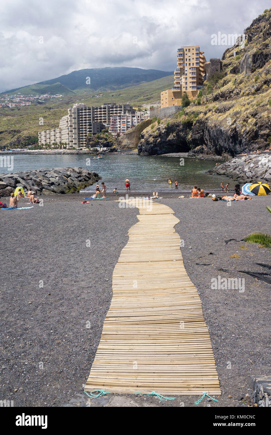 Wooden path at the artificial beach of Radazul, behind the appartment complex of Tabaiba, south-east of Tenerife island, Canary islands, Spain Stock Photo