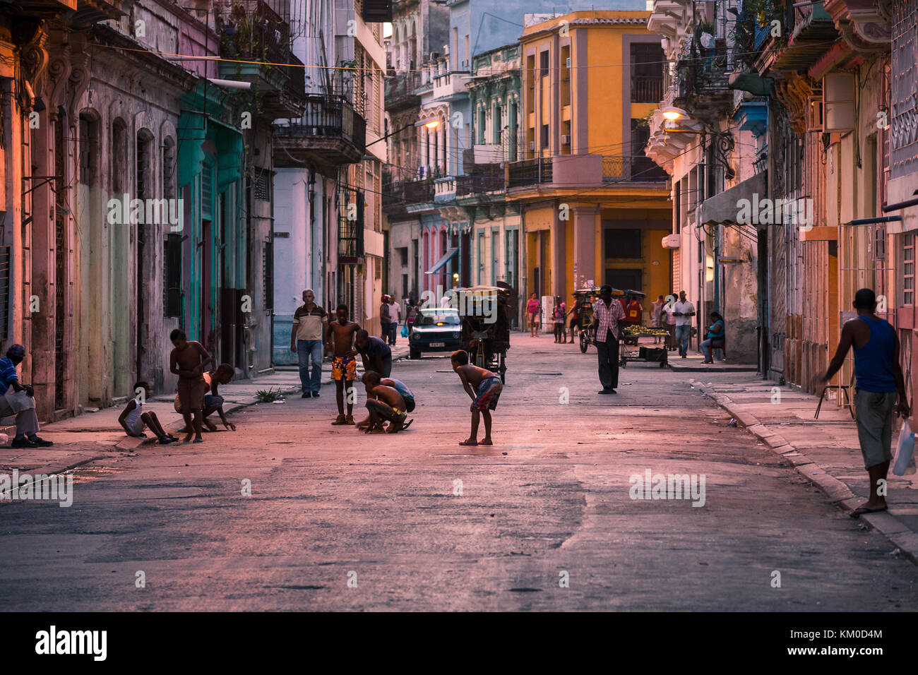 Children play out on the streets of Centro Havana one evening as the sun begins to set and the air begins to cool.  Pictured in August 2014 in Cuba. Stock Photo