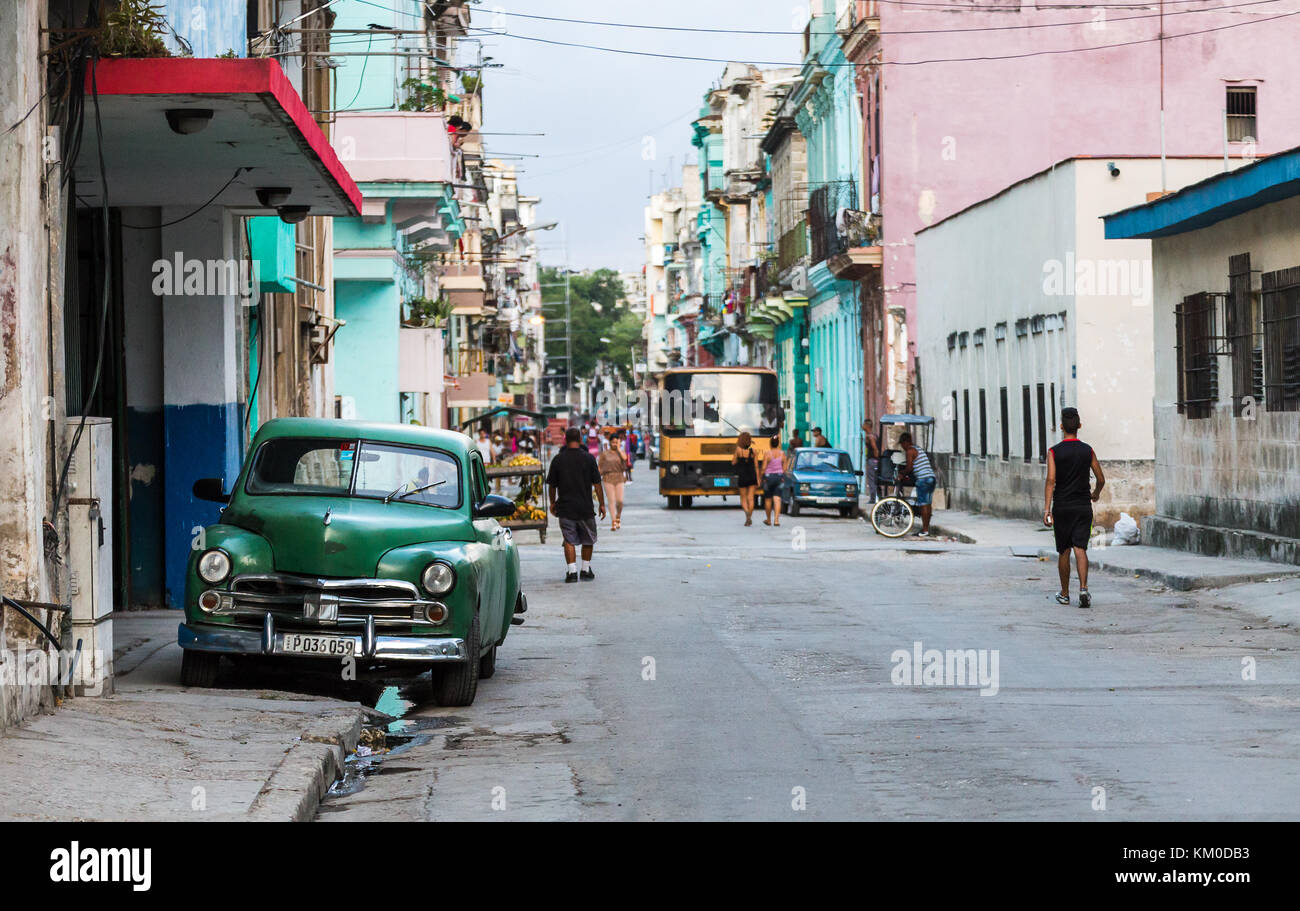 The colours and sights of people going out about their lives on the rugged back streets of Centro Havana in Cuba. Stock Photo