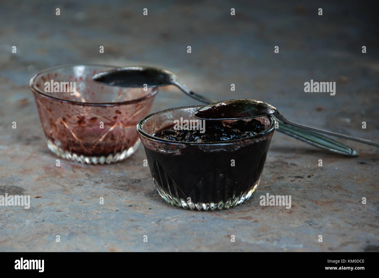 Two bowls of homemade jam, one is empty and one is full. Greedy concept Stock Photo