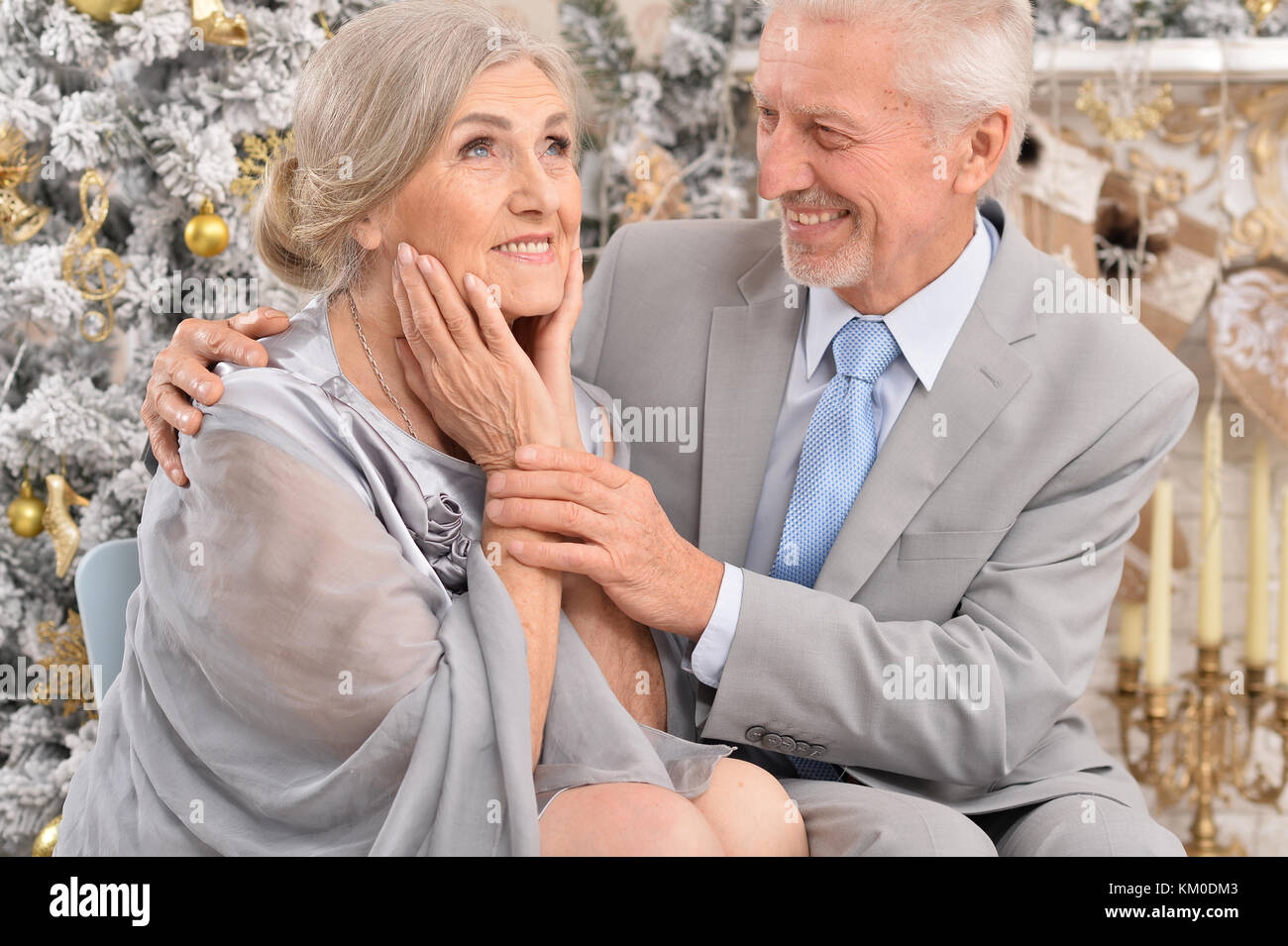 elderly couple near christmas tree Stock Photo Alamy
