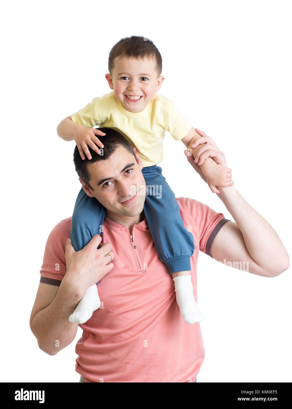 The little boy sits on shoulders at the father isolated on white Stock Photo