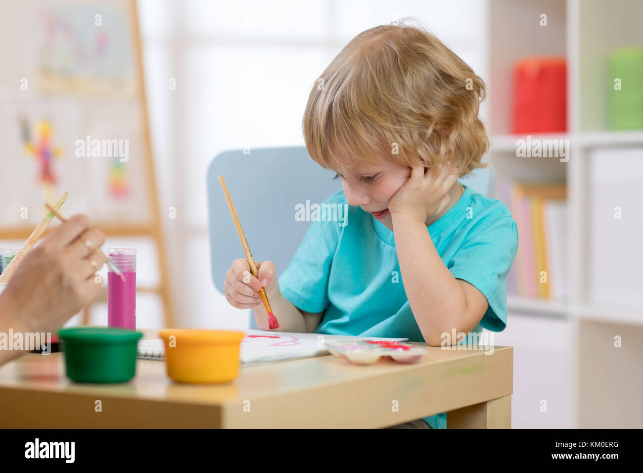 Portrait of little boy drawing something for art class Stock Photo - Alamy