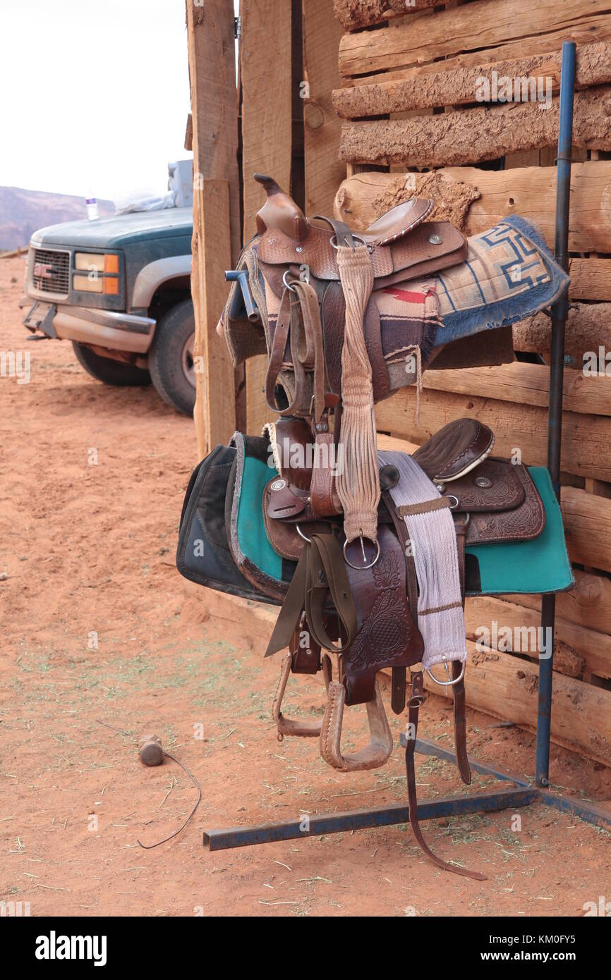 Horse saddles outside stables. Stock Photo