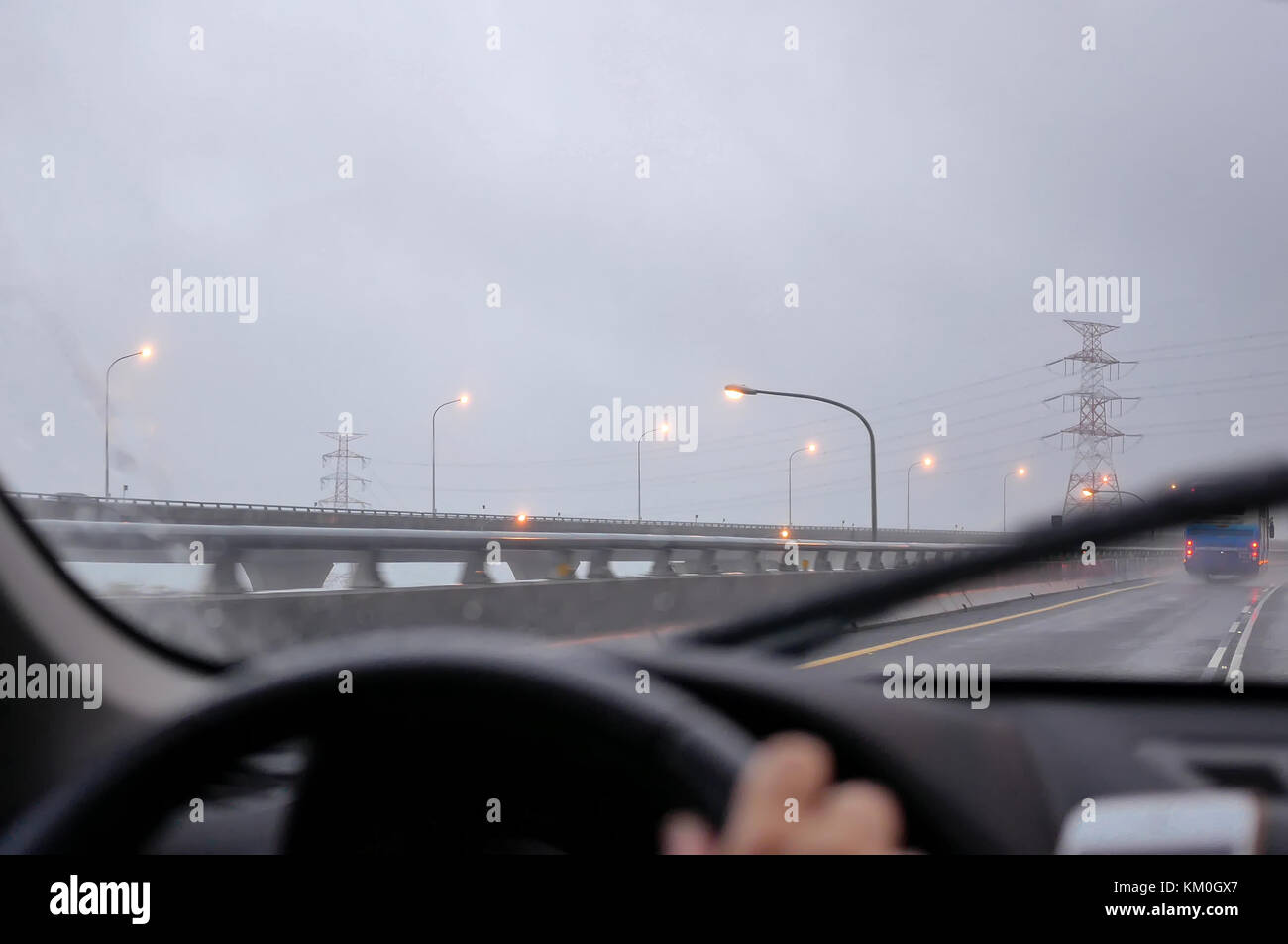Motion of car driving on heavy raining day and focusing on car dashboard Stock Photo