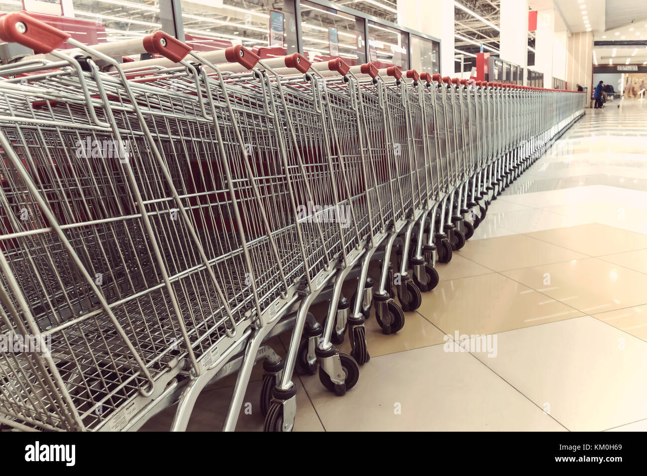 Many shopping carts. Inside a large supermarket. Modern and stylish