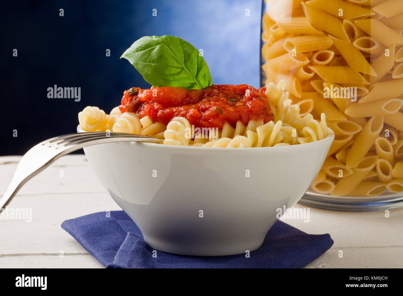 photo of delicious pasta with tomato sauce on blue background Stock Photo