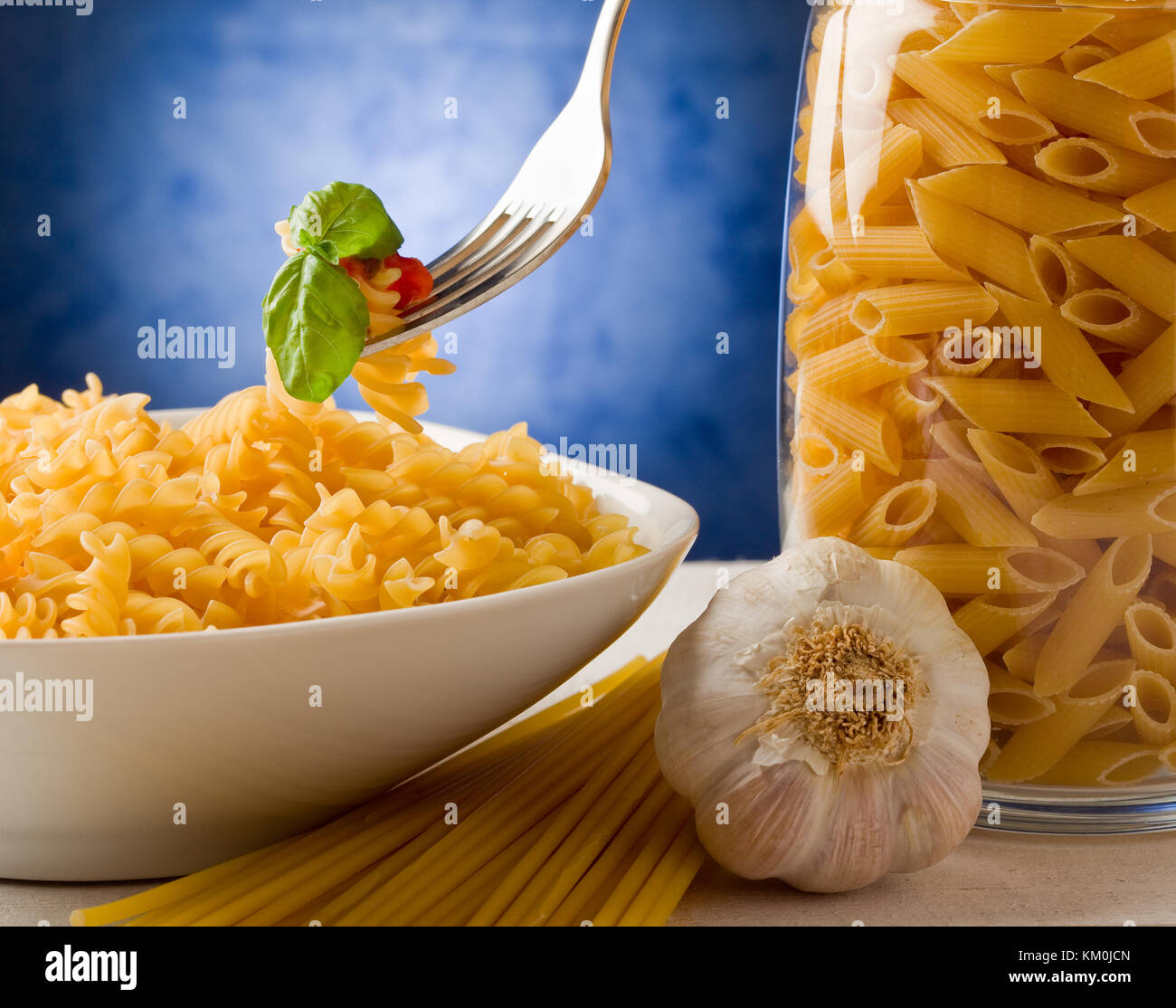 photo of delicious pasta with tomato sauce on blue background Stock Photo