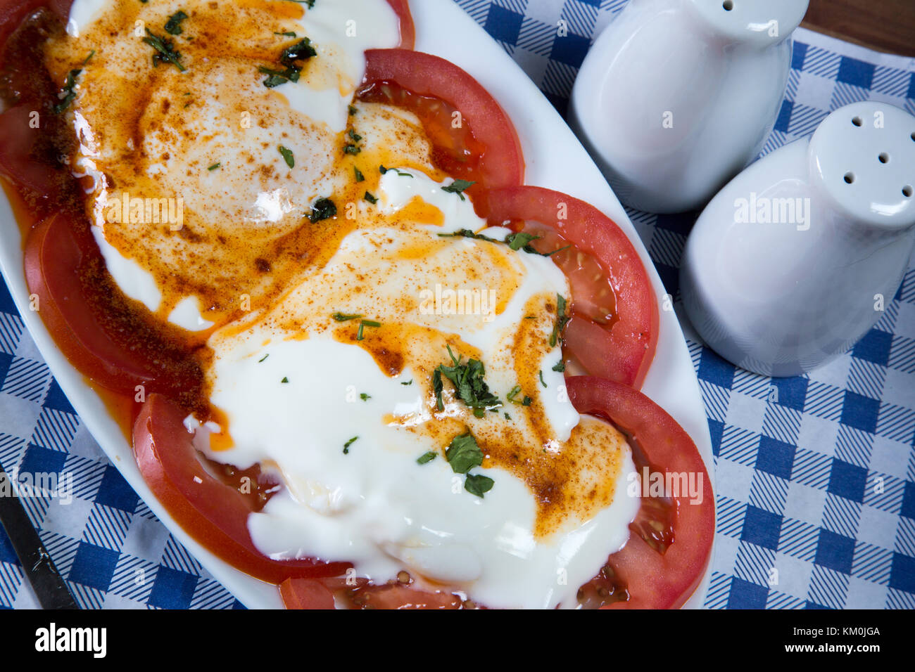 Traditional Turkish breakfast dish of Cilbir, poached egg, Garlic