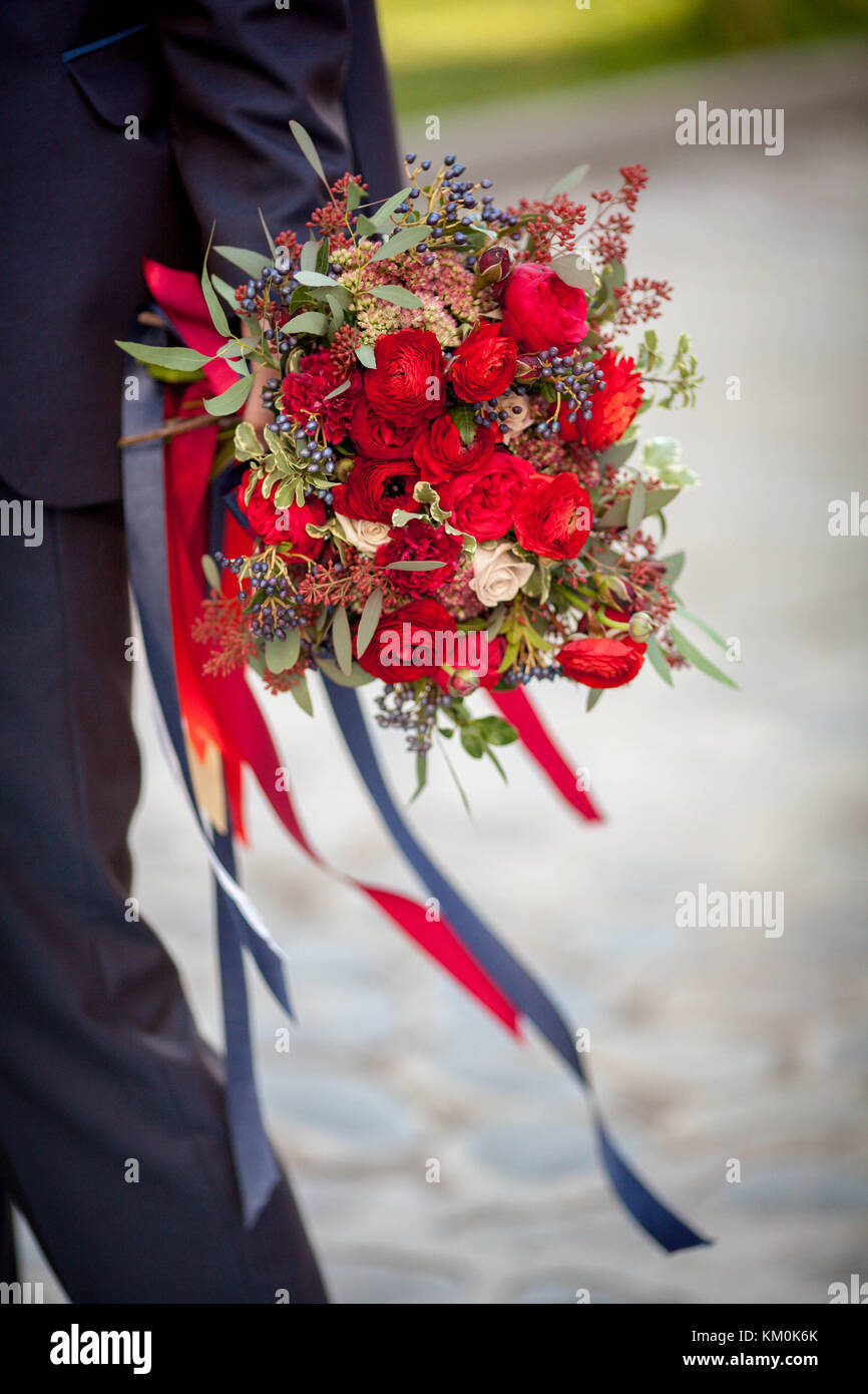 The man is holding a gorgeous bouquet of roses Stock Photo
