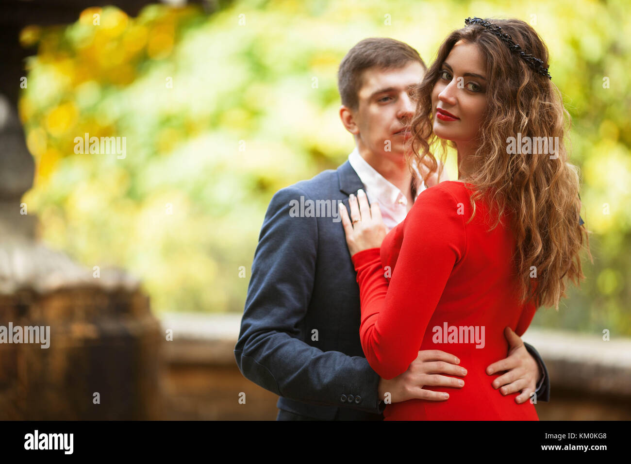 Boy in classical costume hugs the girl in the red dress Stock Photo