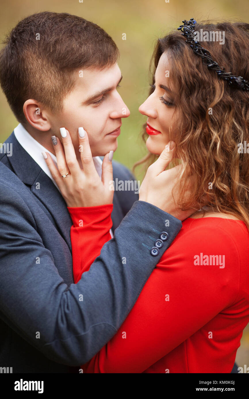 Boy in classical costume hugs the girl in the red dress Stock Photo