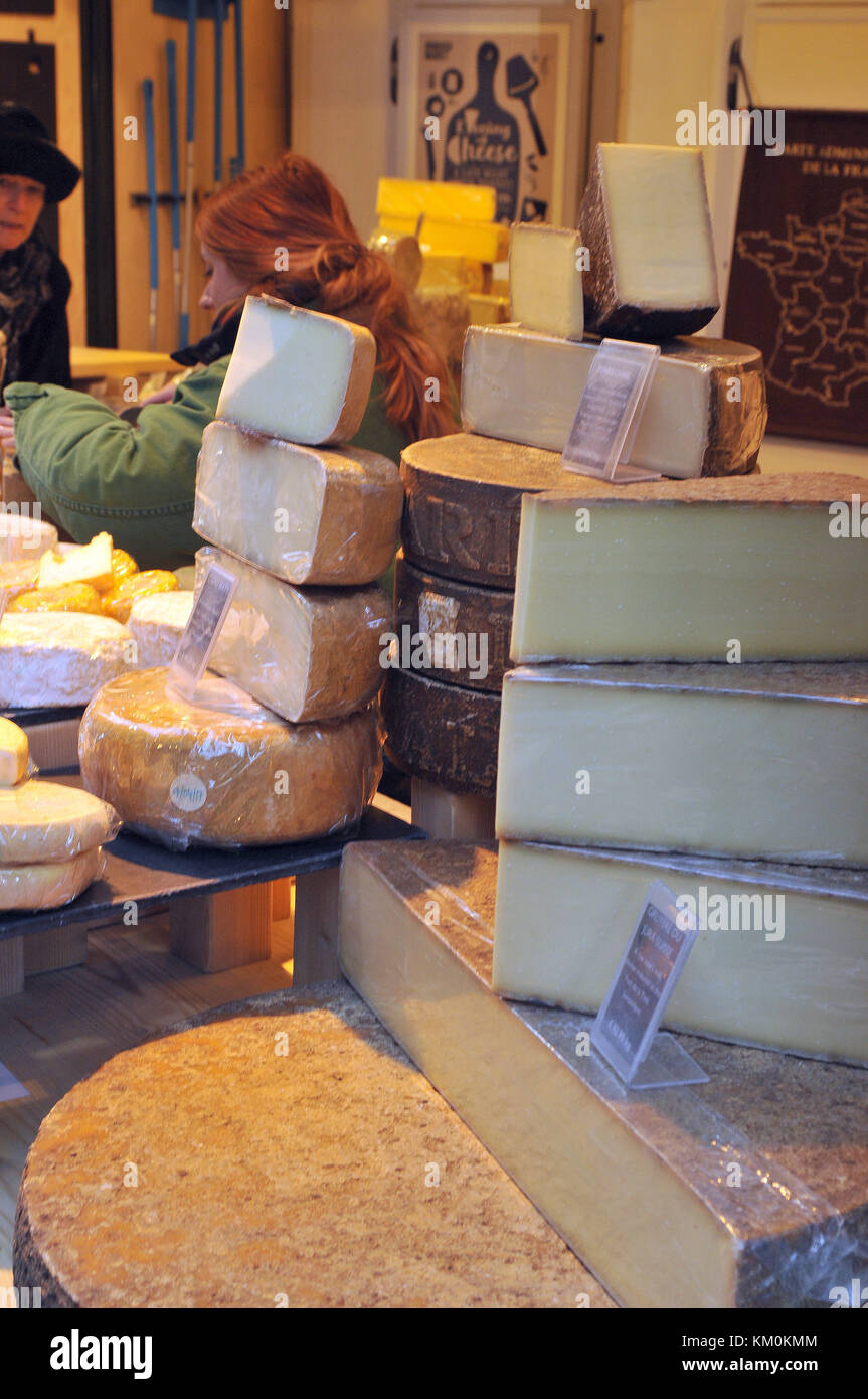 A selection of Swiss and french cheeses for sale on a market stall at