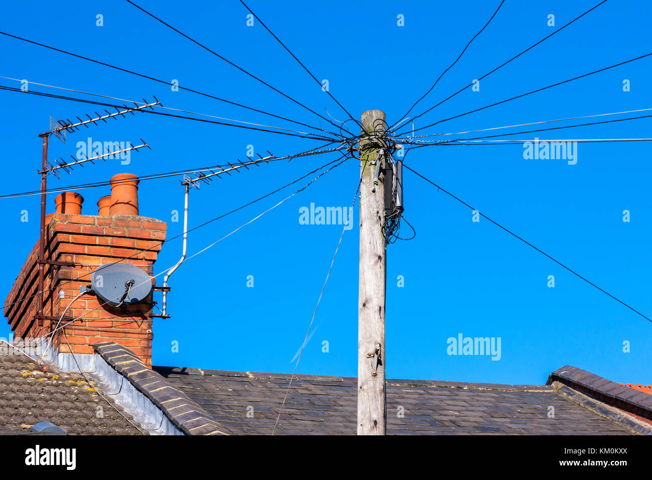 Over head telephone wires spreading out from the pole. Northampton, U.K