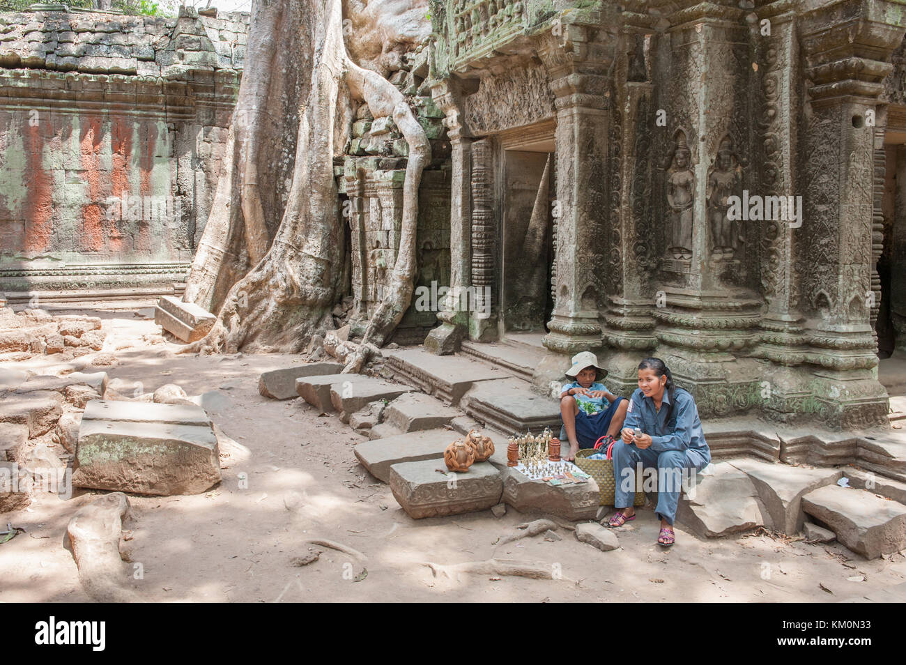 Khmer vendor at Ta Prohm in Siem Reap. Built in 12-13th century Ta Prohm was later the location for the movie Tomb Raider. Stock Photo