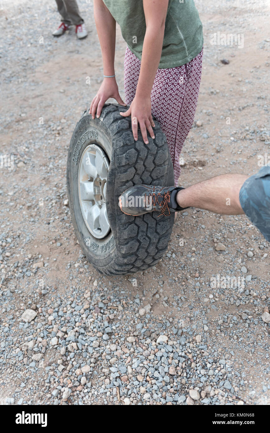 right foot checks the broken car tire Stock Photo