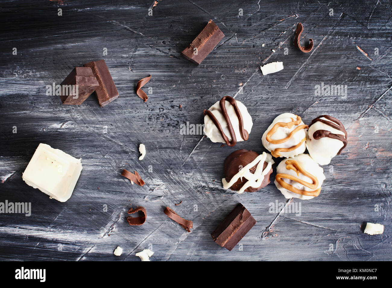 White and Dark Chocolate truffles for Christmas or Valentines's Day with chocolate bark and shavings around them. Stock Photo
