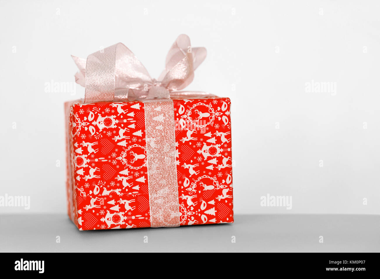 Red gift box with ribbon on white background Stock Photo - Alamy