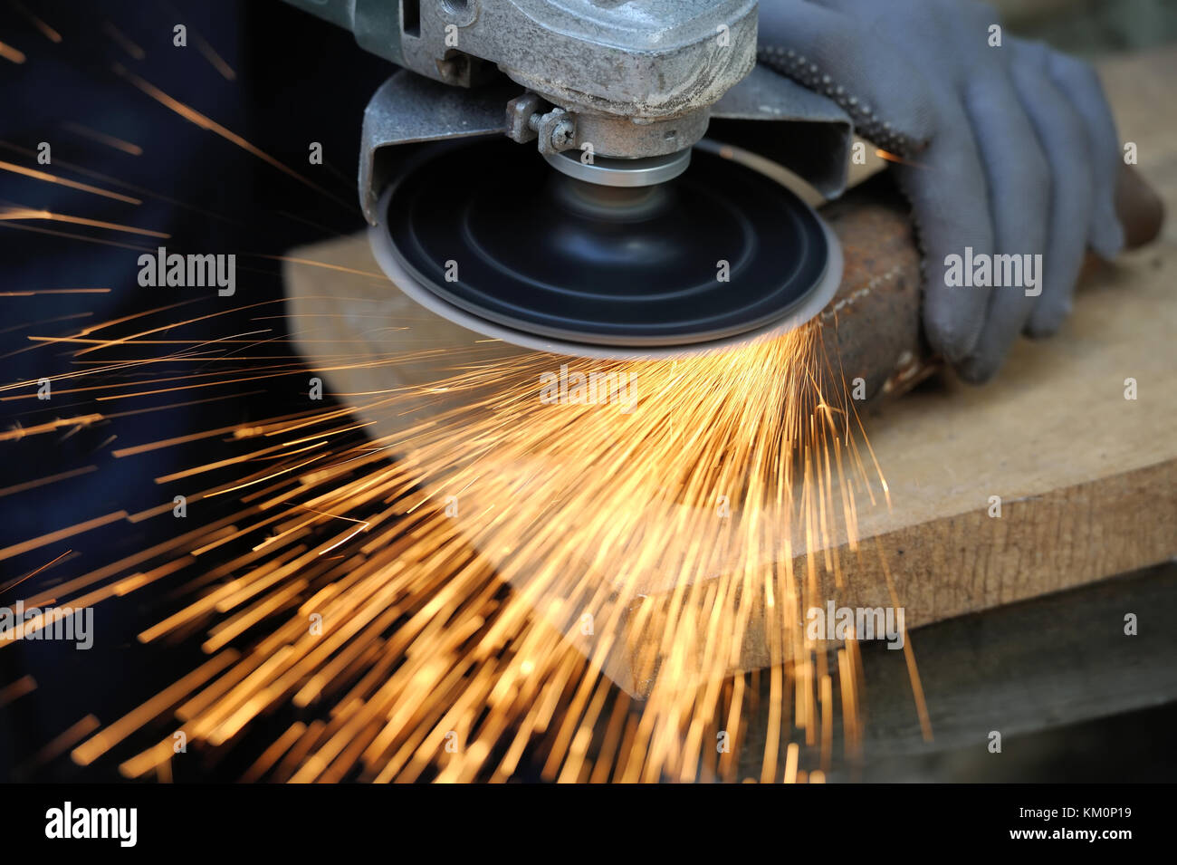 Worker cutting metal with grinder. Sparks while grinding iron Stock