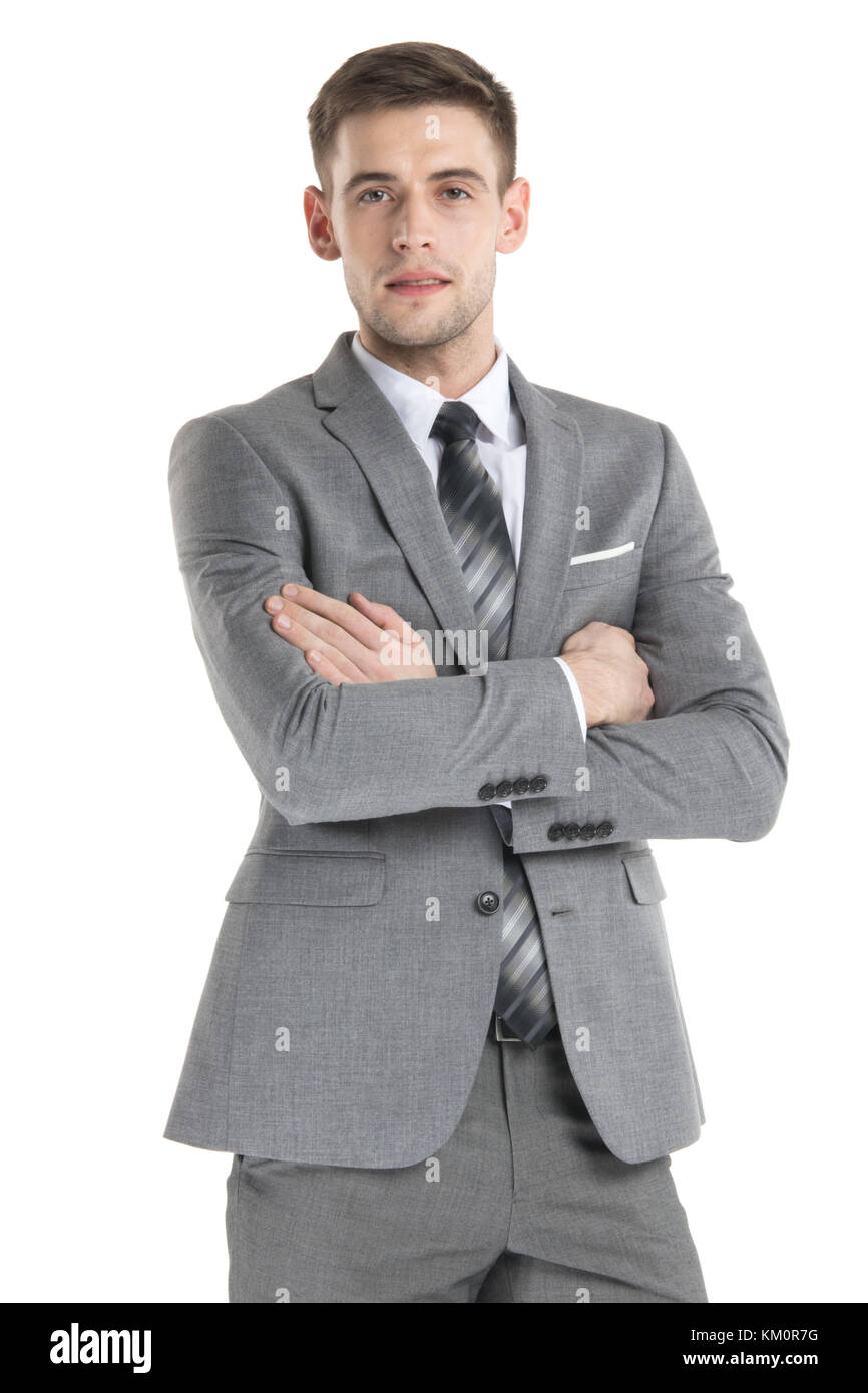 Portrait of a handsome young businessman in suit over white background ...