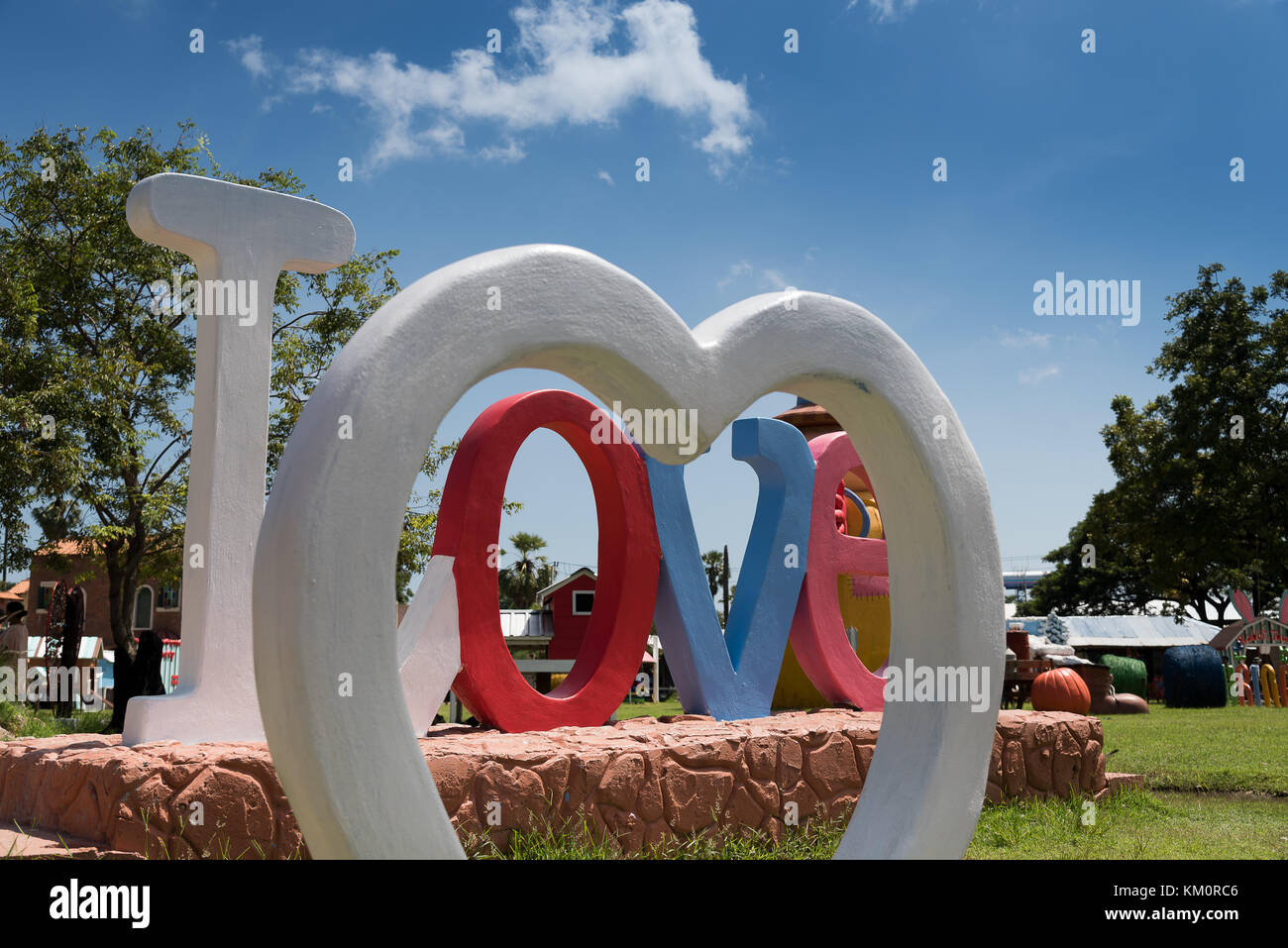 Love word and white heart statues in the park Stock Photo - Alamy