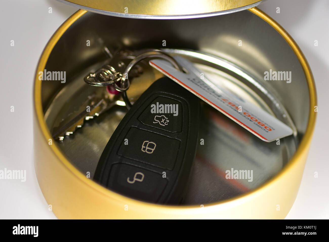 Car keys in a Tin - blocking the signal - Faraday cage Stock Photo - Alamy