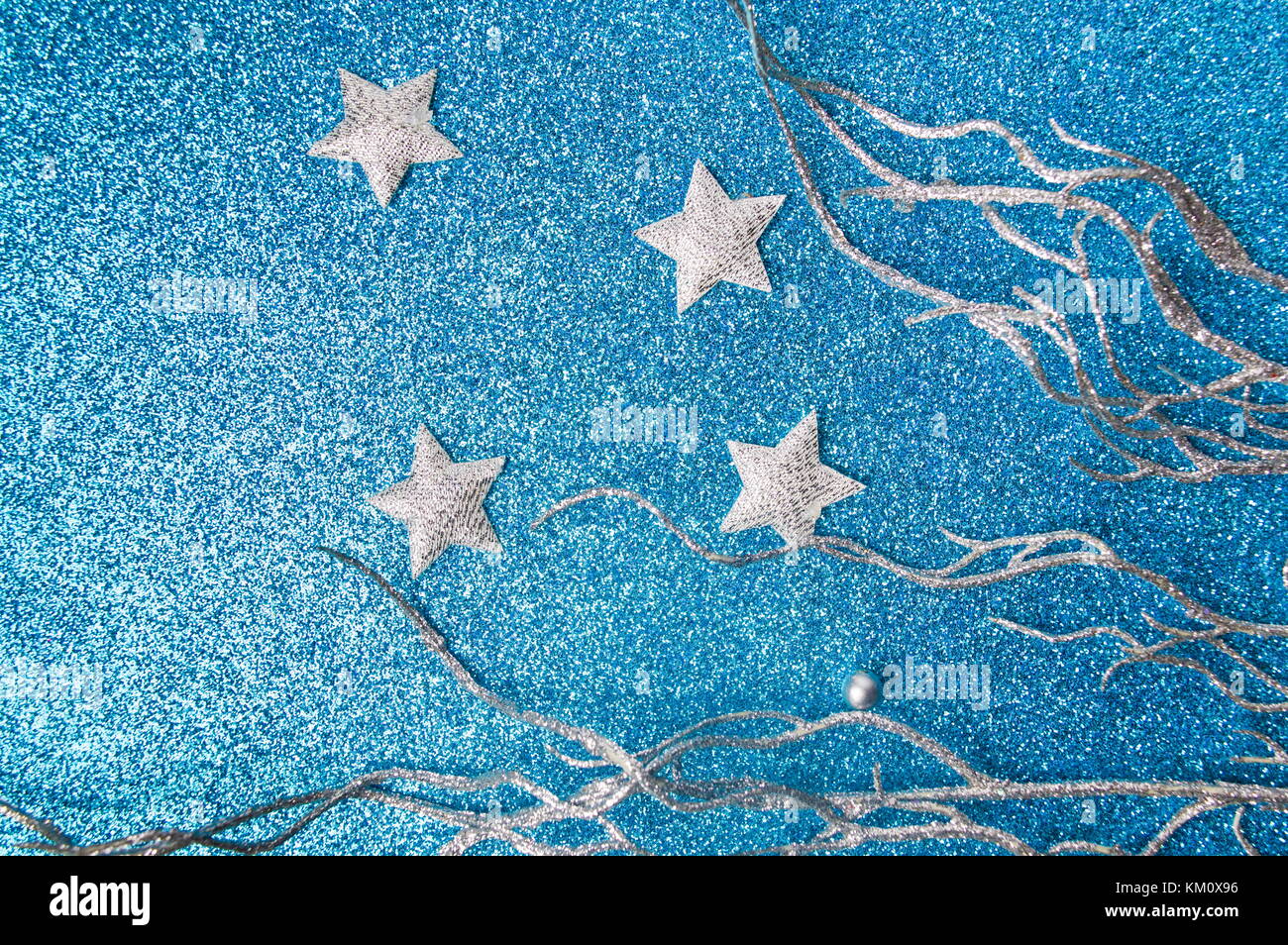 Silver Christmas decorations on shiny blue background Stock Photo