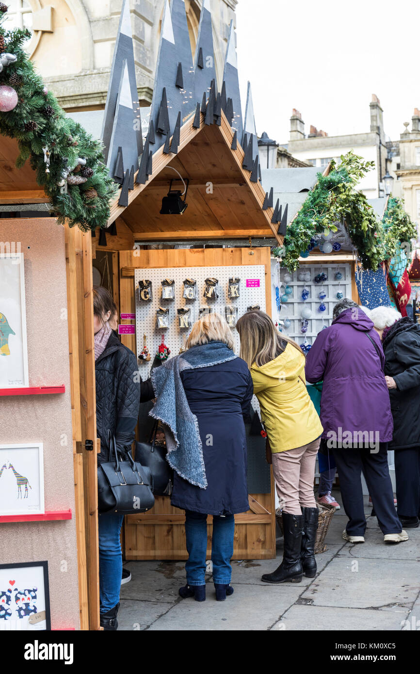 Shoppers at a Bath Christmas Market stall, Bath, England, UK Stock