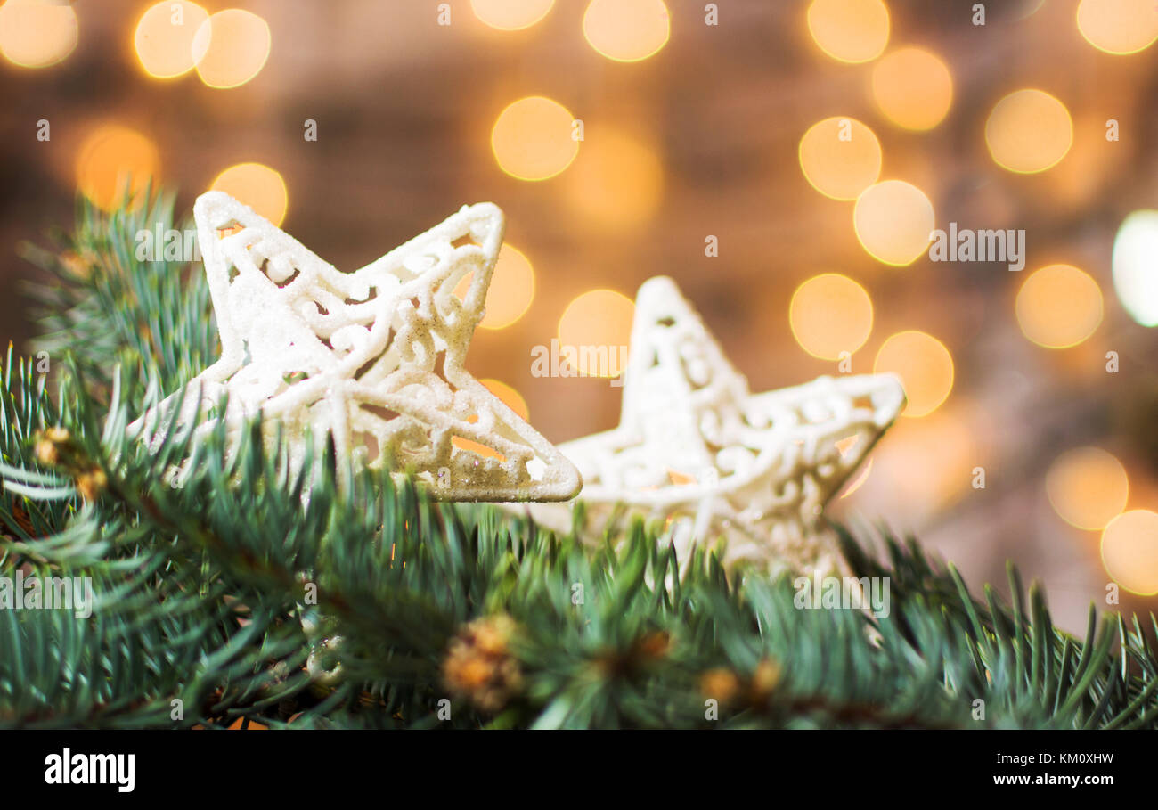 Silver stars on a Christmas tree with festive background Stock Photo