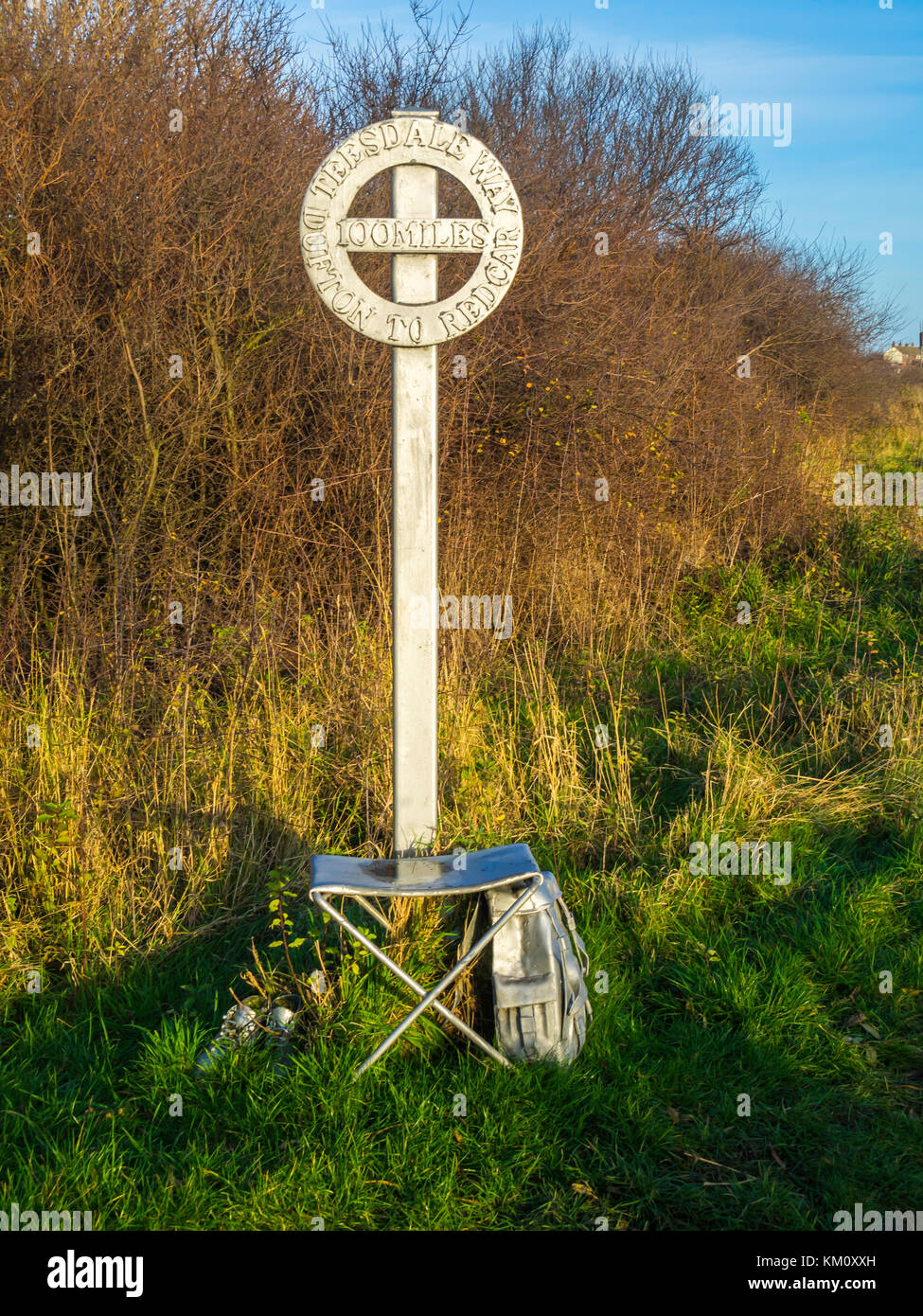 Coatham Marsh Nature reserve a sculpture of a signpost rucksack and stool marking the end of the Teesdale Way long distance walk Stock Photo