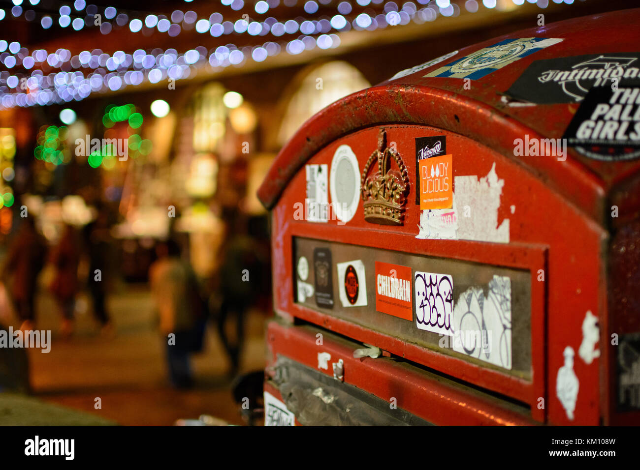 Mail box close up in Camden, London (UK) with blurred Christmas lights on the background. Landscape format. Stock Photo