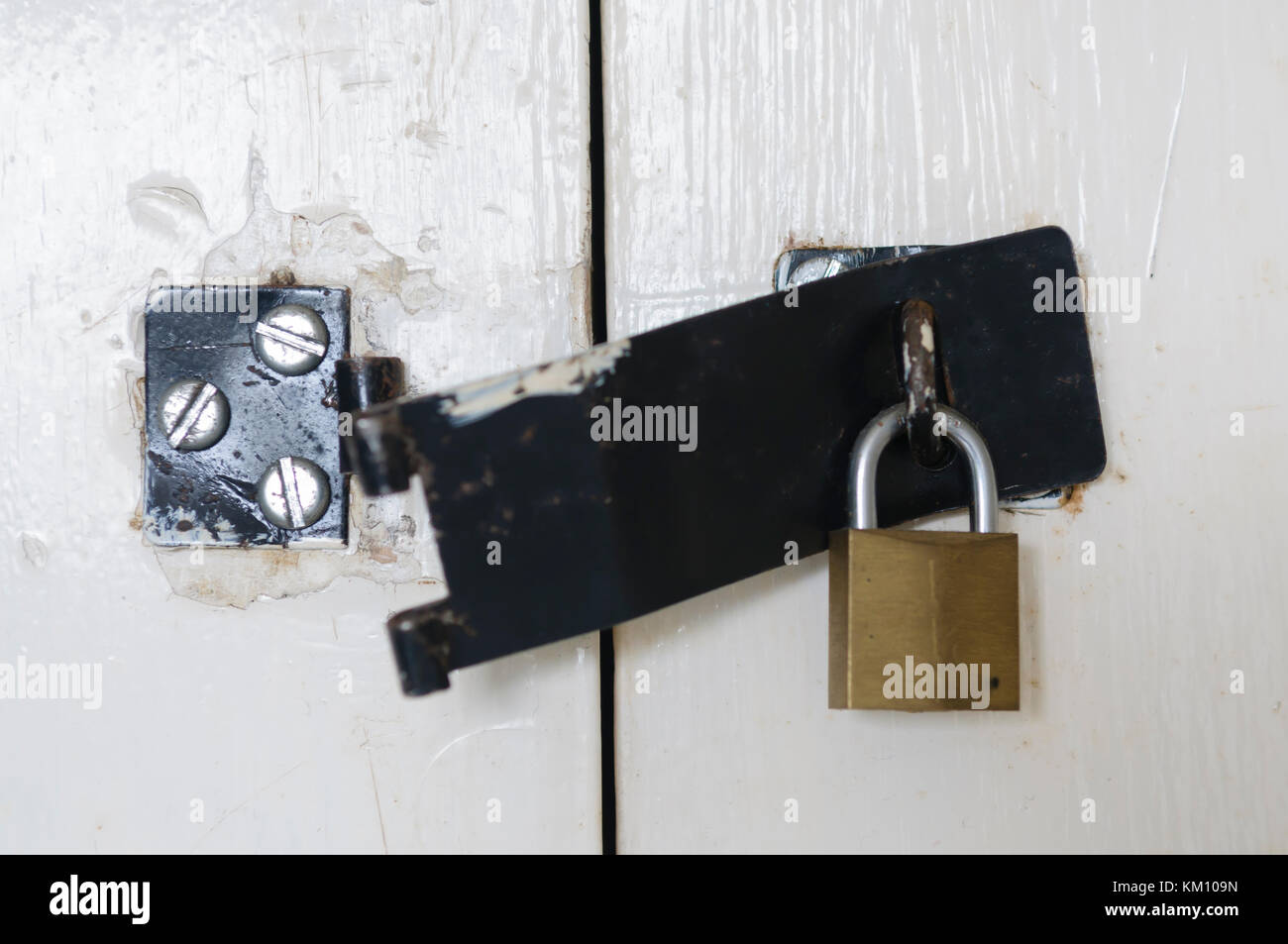 Broken latch with padlock still in place Stock Photo