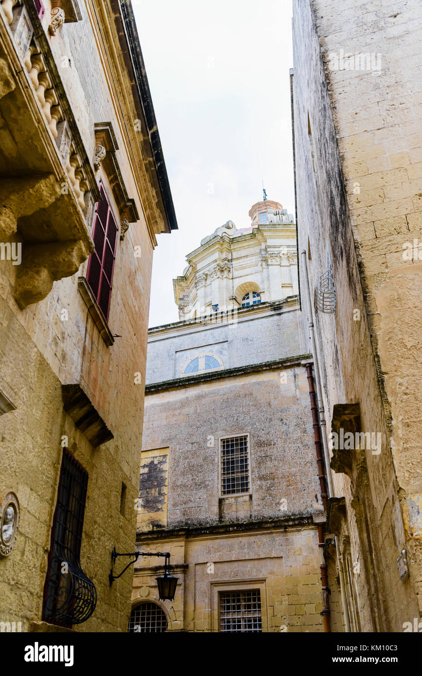 Buildings in Mdina, Malta, with the dome of Saint Paul's Cathedral in the background. Stock Photo
