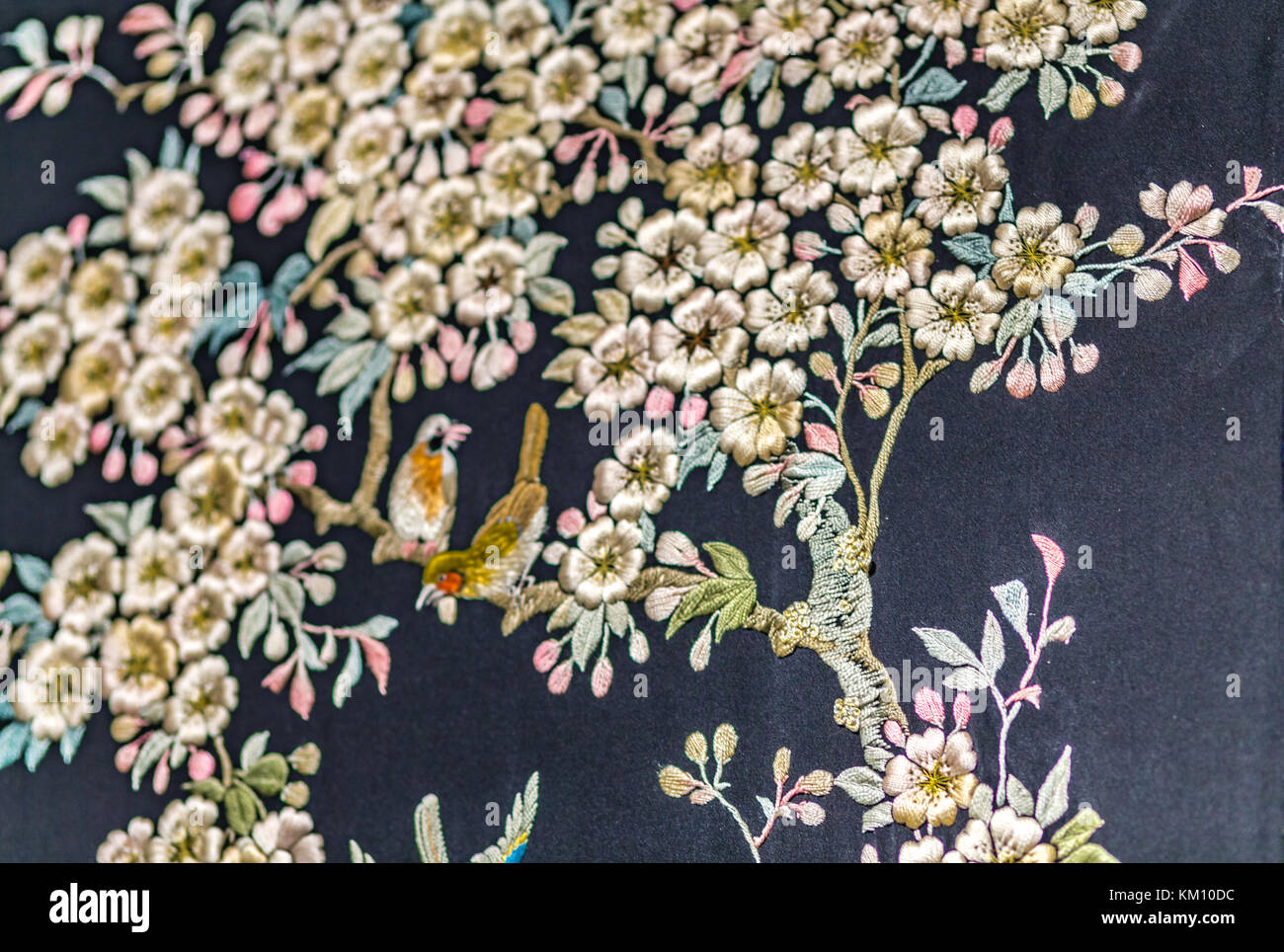 oriental embroidery on fabric, trees, flowers and birds Stock Photo