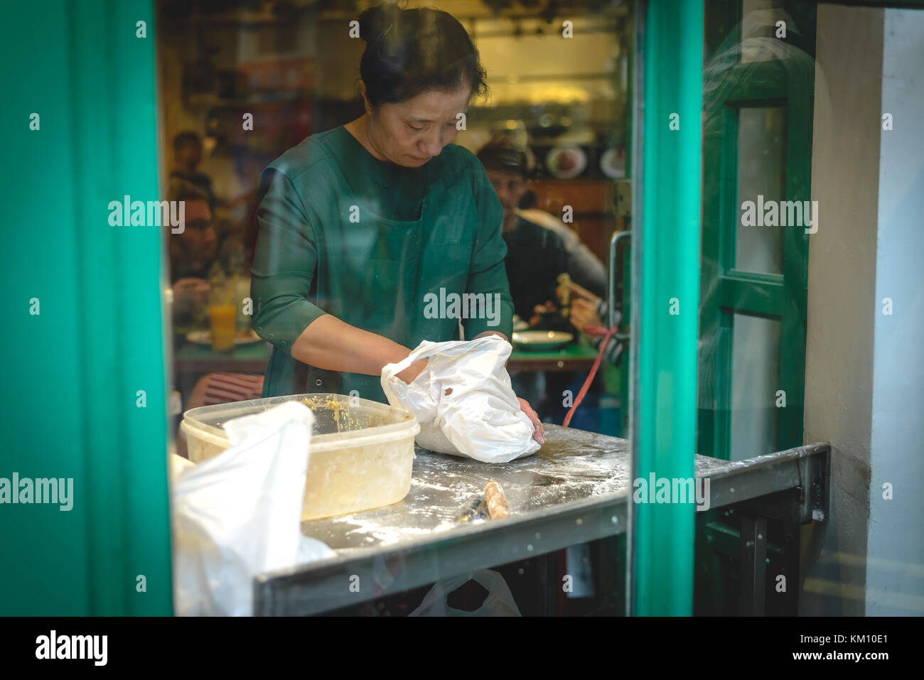 Woman preparing dumplings in an Asian restaurant in Chinatown. London (UK), July 2017. Stock Photo