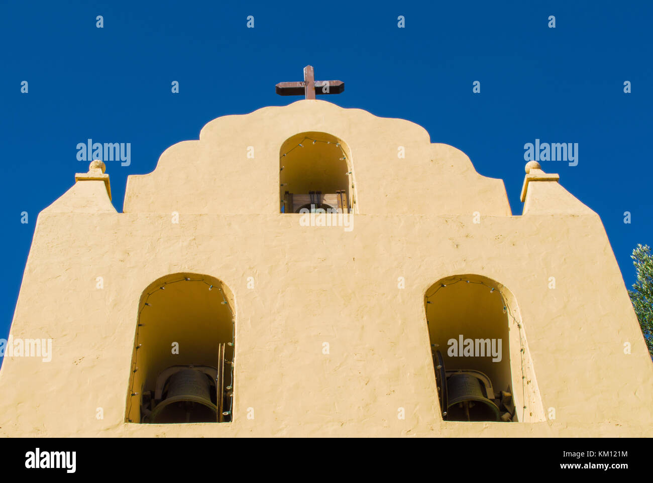 adobe mission bell tower with cross at top viewed from below Stock Photo